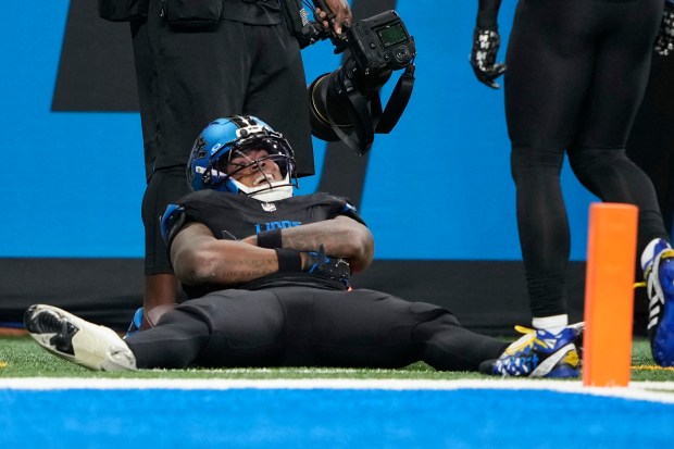 Detroit Lions running back Jahmyr Gibbs reacts after a long...
