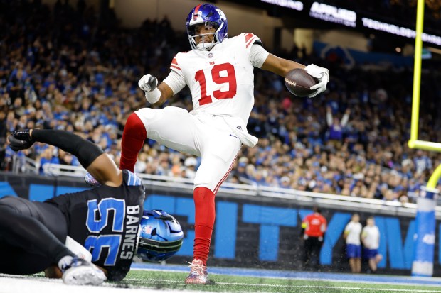 New York Giants quarterback Jameis Winston (19) breaks the tackle...