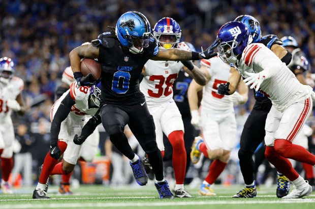 Detroit Lions running back Jahmyr Gibbs (0) runs against the...