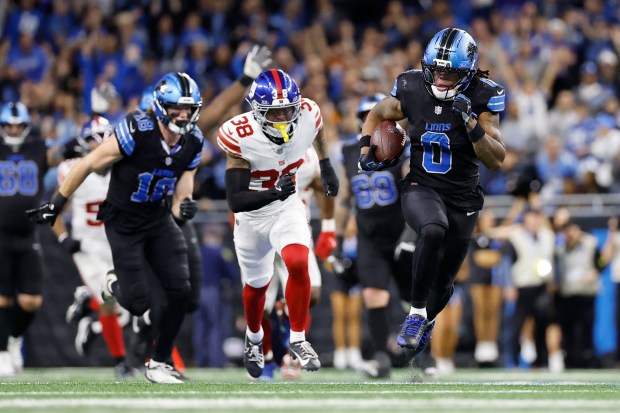 Detroit Lions running back Jahmyr Gibbs (0) breaks away from...