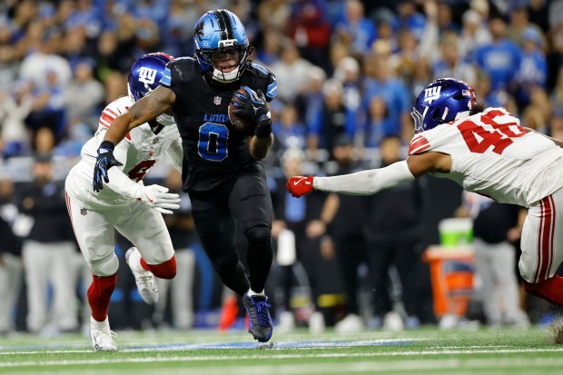 Detroit Lions running back Jahmyr Gibbs (0) runs past New...