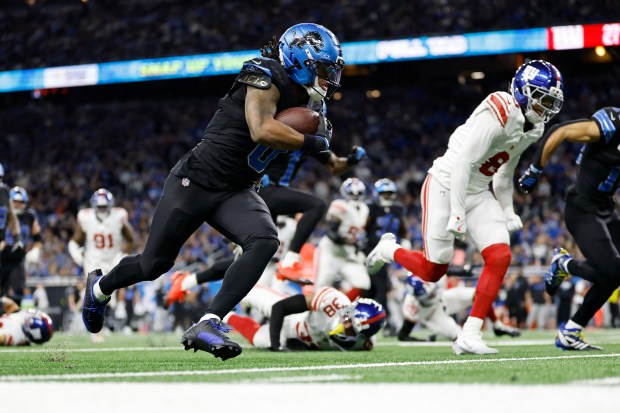 Detroit Lions running back Jahmyr Gibbs (0) runs for a...