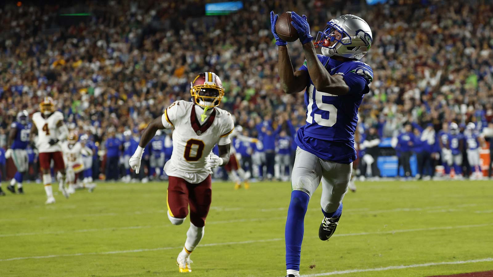Seattle Seahawks wide receiver Tory Horton (15) catches a touchdown pass as Washington Commanders cornerback Mike Sainristil (0) watches during the second quarter at Northwest Stadium. Mandatory Credit: G