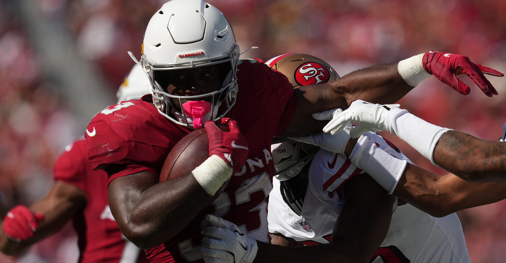 Sep 21, 2025; Santa Clara, California, USA; Arizona Cardinals running back Trey Benson (33) carries the ball as San Francisco 49ers safety Jason Pinnock (25) defends during the second half at Levi's Stadium. Mandatory Credit: Cary Edmondson-Imagn Images
