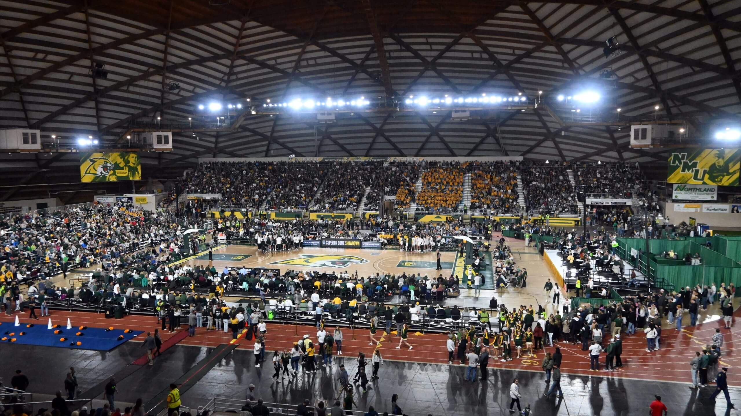 A packed Superior Dome watches an October basketball game.