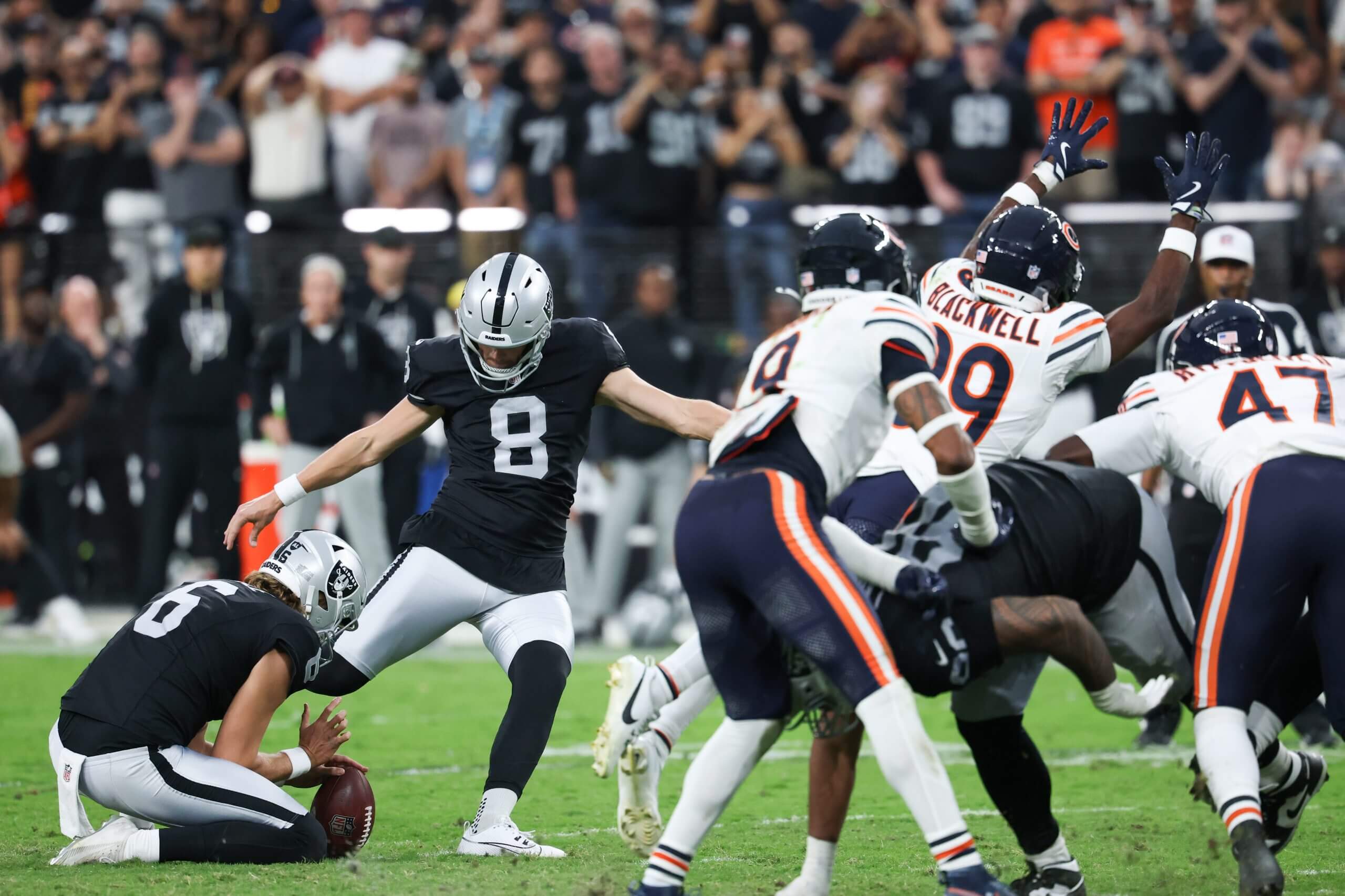 Las Vegas Raiders kicker Daniel Carlson (8) attempts a field goal kick during the second half against the Chicago Bears at Allegiant Stadium. The kick was blocked by the Bears.