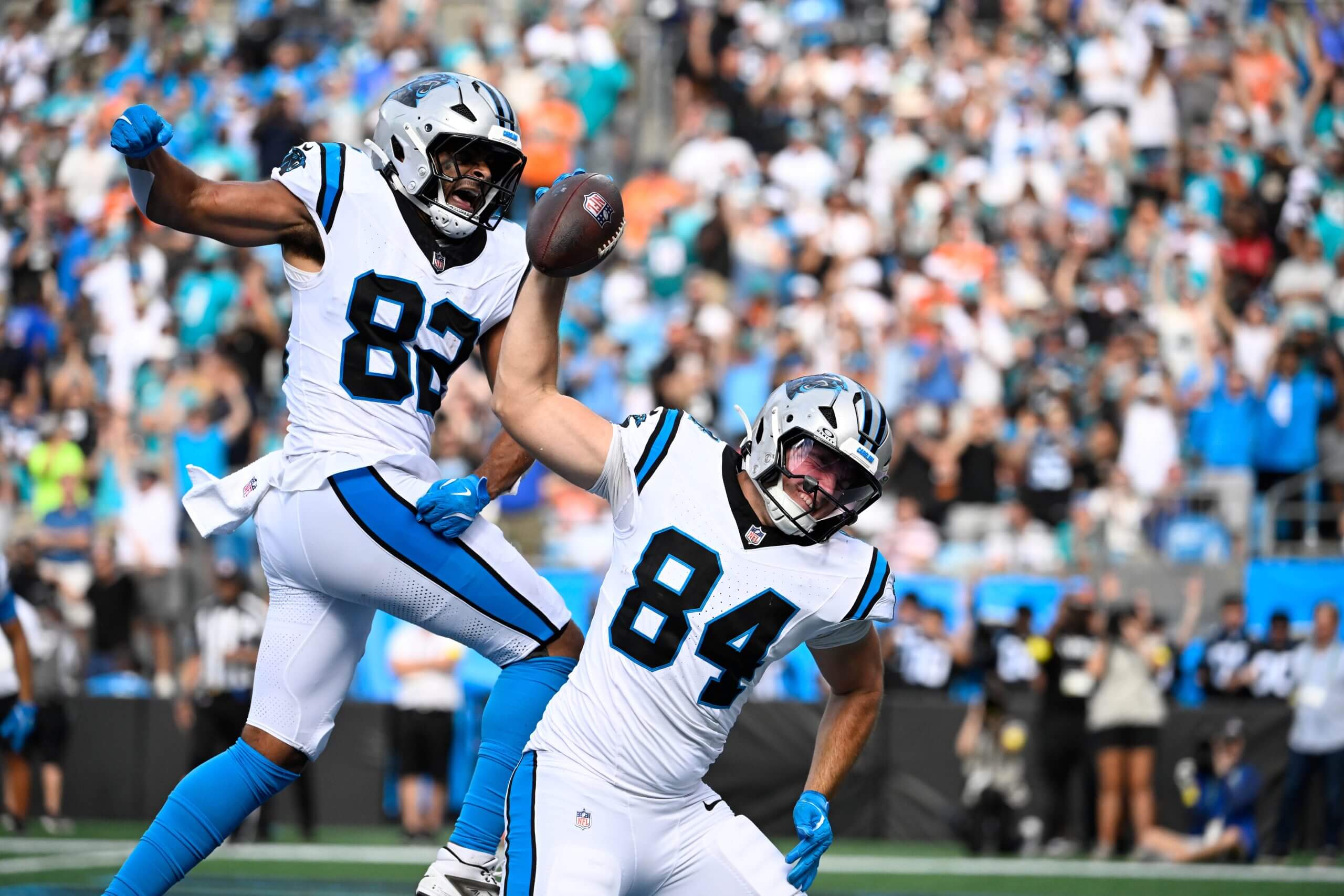 Carolina tight end Mitchell Evans (84) prepares to spike the football with his right hand as teammate Tommy Tremble celebrates behind him after Evans scored a touchdown.