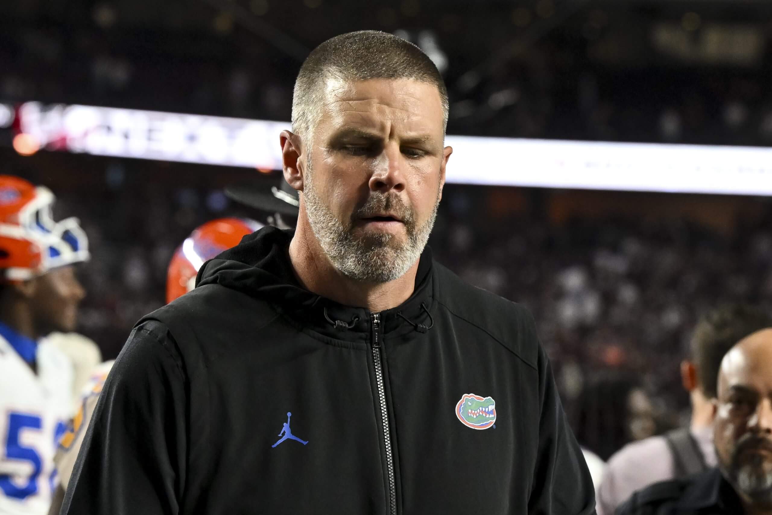 Former Florida football coach Billy Napier looks down while walking off the field after a game