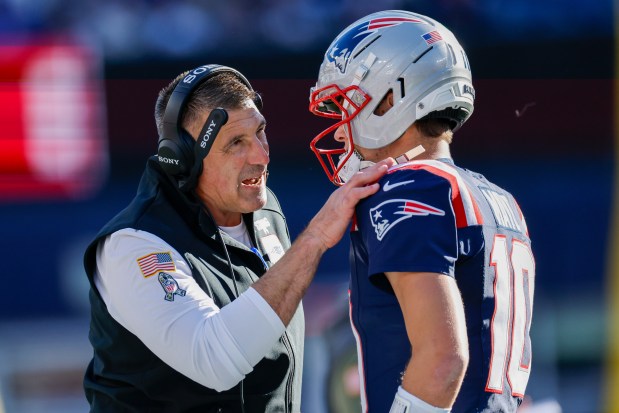 Patriots head coach Mike Vrabel talks with quarterback Drake Maye during the first half of an NFL game against the Atlanta Falcons in Foxboro. (AP Photo/Greg M. Cooper)