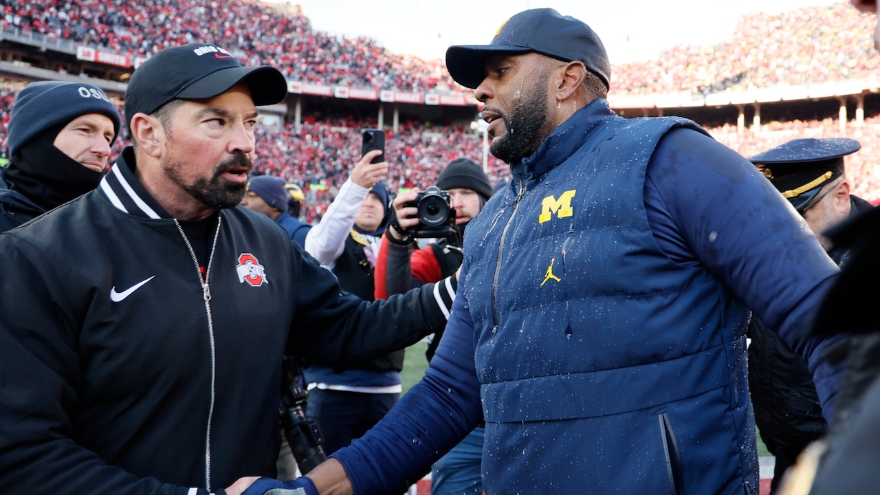 Ohio State head coach Ryan Day, left, and Michigan head coach Sherrone Moore shake hands after an NCAA college football game Saturday, Nov. 30, 2024, in Columbus, Ohio.