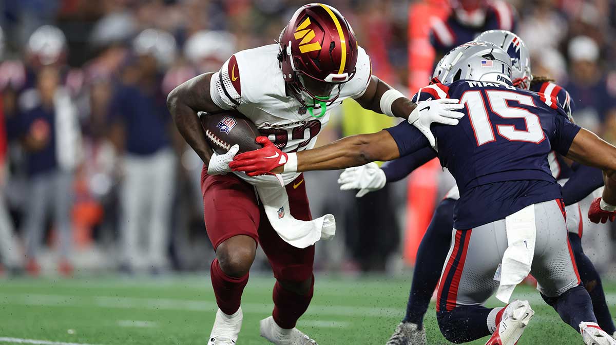 Washington Commanders running back Jacory Croskey-Merritt (32) runs the ball during the first half against the New England Patriots at Gillette Stadium.
