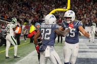 New England Patriots' TreVeyon Henderson celebrates withHunter Henry after scoring a...