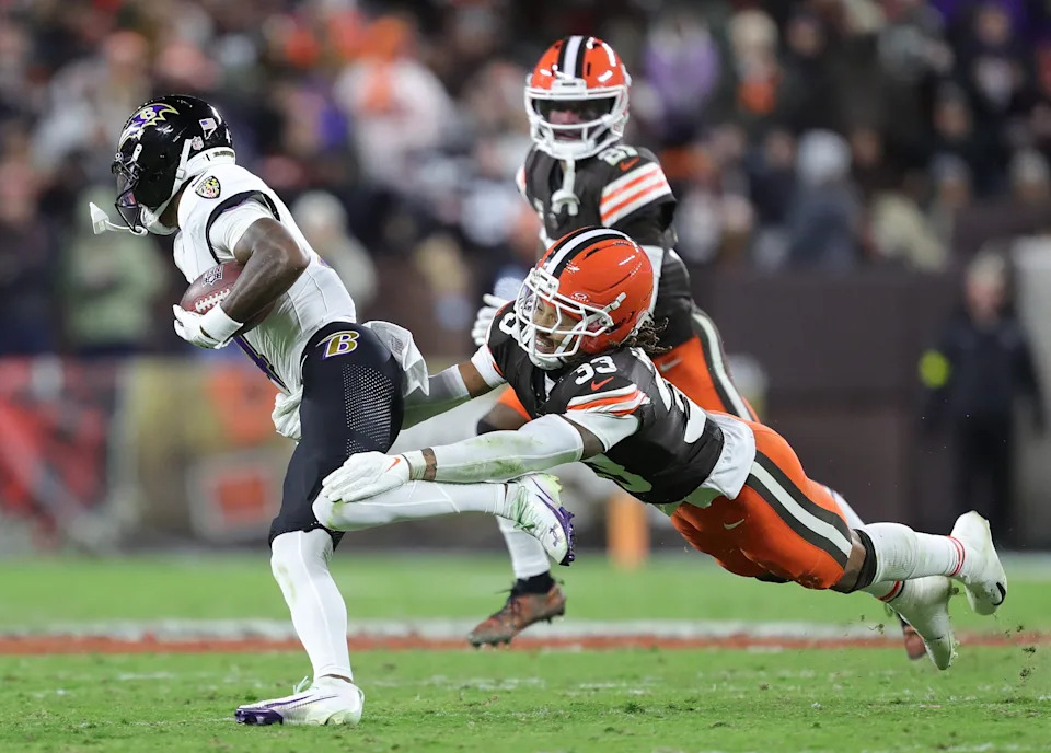 Cleveland Browns safety Ronnie Hickman (33) makes a diving attempt for Baltimore Ravens wide receiver Zay Flowers (4) during the second half of an NFL football game at Huntington Bank Field, Nov. 16, 2025, in Cleveland, Ohio.