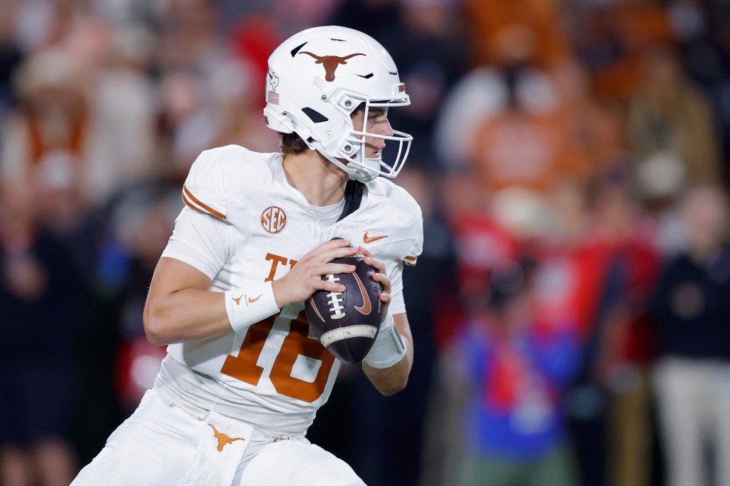Arch Manning, #16 of the Texas Longhorns, looking to pass the ball during an American college football game.