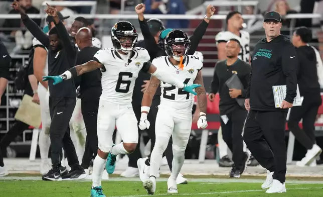 Jacksonville Jaguars cornerback Greg Newsome II (6) and safety Cam'Ron Silmon-Craig (24) celebrate after winning an NFL football game against the Arizona Cardinals in overtime Sunday, Nov. 23, 2025, in Glendale, Ariz. (AP Photo/Ross D. Franklin)