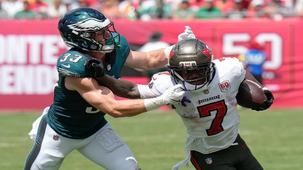 Tampa Bay Buccaneers running back Bucky Irving (7) is stopped by Philadelphia Eagles cornerback Cooper Dejean (33) during the first half of an NFL football game Sunday, Sept. 28, 2025, in Tampa, Fla. (AP Photo/Chris O'Meara)