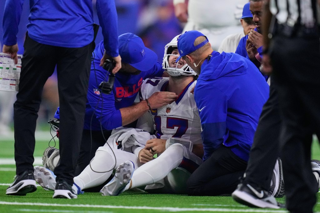 Buffalo Bills quarterback Josh Allen is attended to by medical staff after being sacked by Will Anderson Jr.