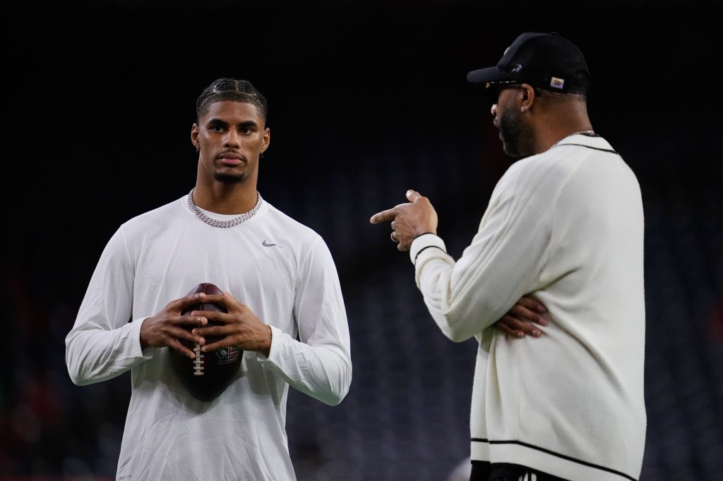 Buffalo Bills wide receiver Keon Coleman, left, talks with Tracy McGrady, right, during warmups before an NFL football game against the Houston Texans Thursday, November 20, 2025, in Houston. 
