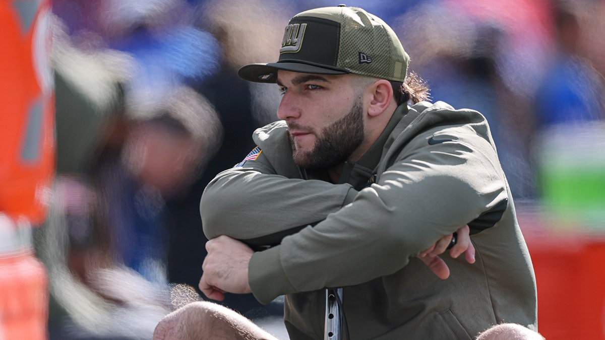 Cam Skattebo sits on scooter