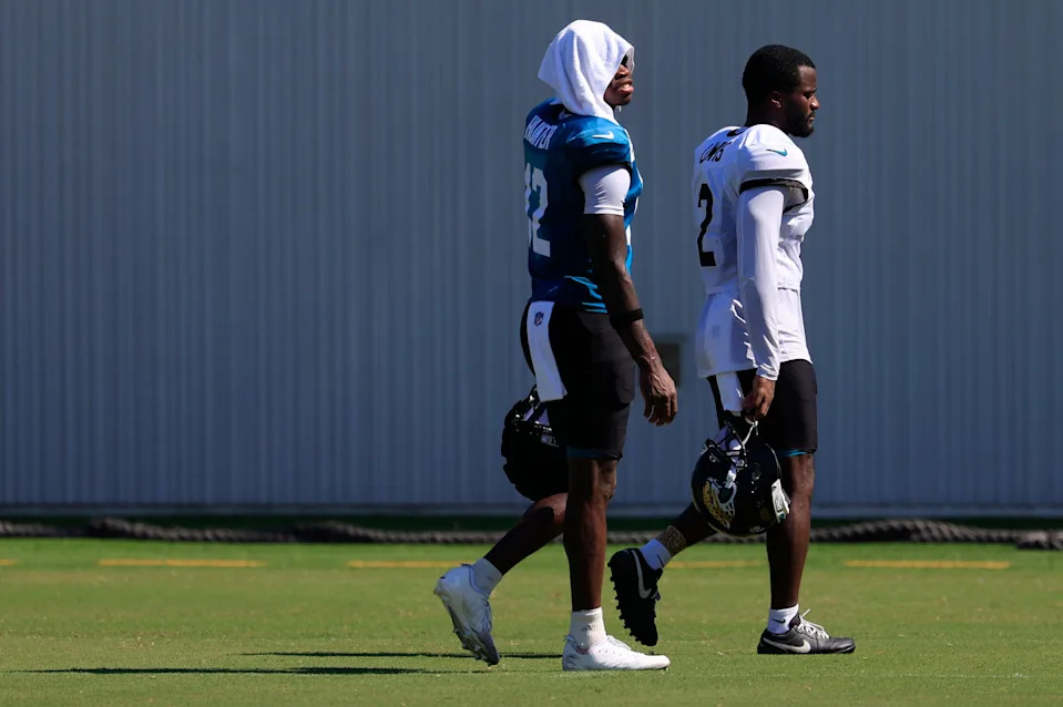 Jacksonville Jaguars wide receiver Travis Hunter (12) walks off the field with cornerback Jourdan Lewis (2) after an NFL training camp session at the Miller Electric Center, Wednesday, Aug. 6, 2025, in Jacksonville, Fla. [Corey Perrine/Florida Times-Union]