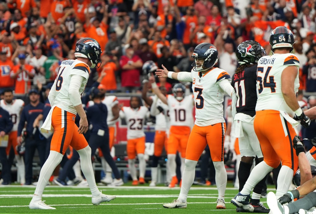 Denver Broncos place kicker Wil Lutz (3) celebrates with punter Jeremy Crawshaw (16) after kicking a game-winning field goal during the fourth quarter against the Houston Texans at NRG Stadium. 