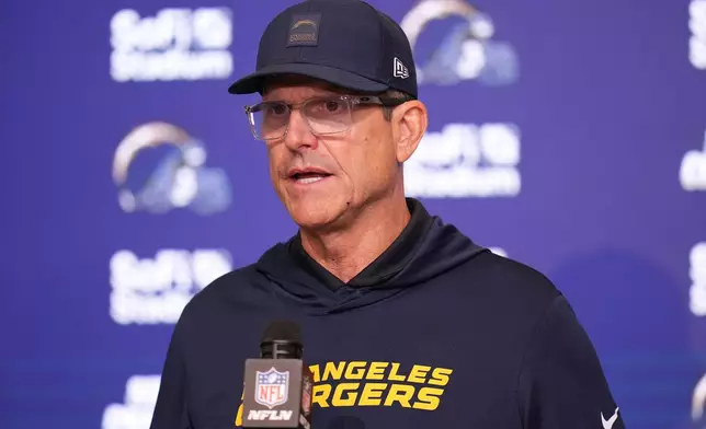 Los Angeles Chargers head coach Jim Harbaugh answers questions after an NFL football game against the Minnesota Vikings Thursday, Oct. 23, 2025, in Inglewood, Calif. (AP Photo/Gregory Bull)