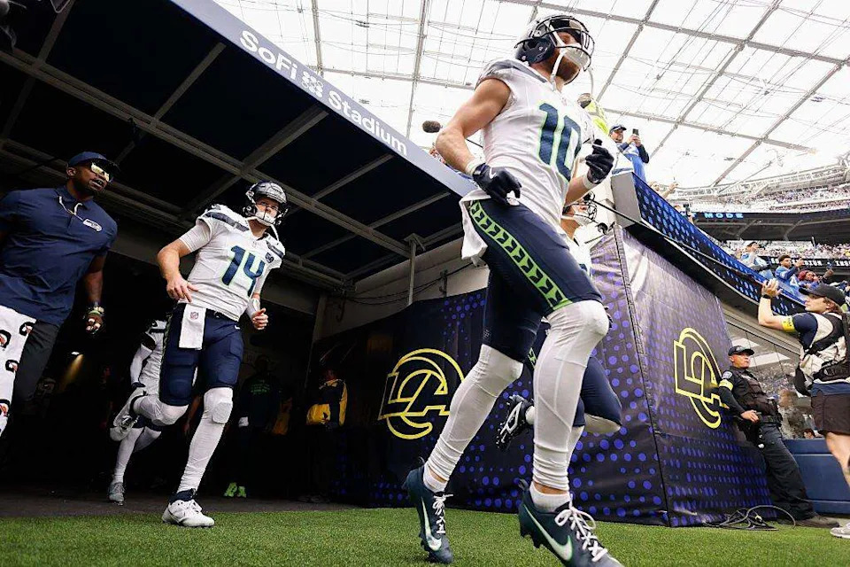 Seattle Seahawks wide receiver Cooper Kupp (10) and quarterback Sam Darnold (14) run onto the field before the game against the Los Angeles Rams at SoFi Stadium on November 16, 2025 in Inglewood, California. (Photo by Harry How/Getty Images) Harry How/Getty Images