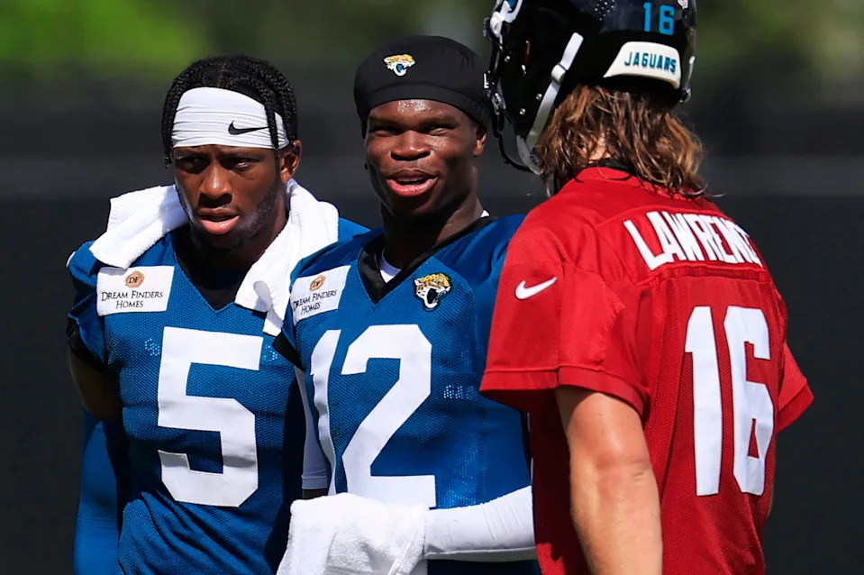 Jacksonville Jaguars wide receiver Travis Hunter (12) talks with quarterback Trevor Lawrence (16) as wide receiver Dyami Brown (5) looks on after an NFL training camp session at the Miller Electric Center, Sunday, Aug. 3, 2025, in Jacksonville, Fla. [Corey Perrine/Florida Times-Union]