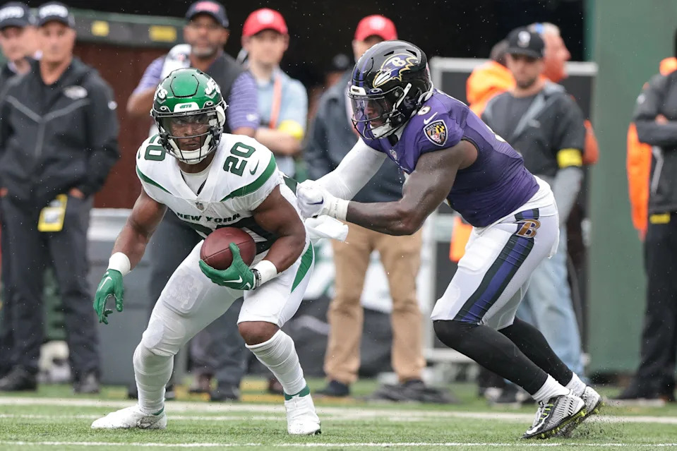 Sep 11, 2022; East Rutherford, New Jersey, USA; New York Jets running back Breece Hall (20) runs as Baltimore Ravens linebacker Patrick Queen (6) tackles during the second half at MetLife Stadium. Mandatory Credit: Vincent Carchietta-USA TODAY Sports