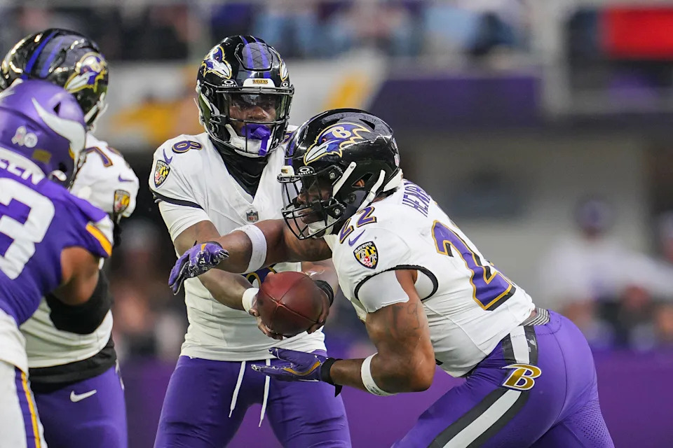 Nov 9, 2025; Minneapolis, Minnesota, USA; Baltimore Ravens quarterback Lamar Jackson (8) hands the ball off to running back Derrick Henry (22) against the Minnesota Vikings in the third quarter at U.S. Bank Stadium. Mandatory Credit: Brad Rempel-Imagn Images
