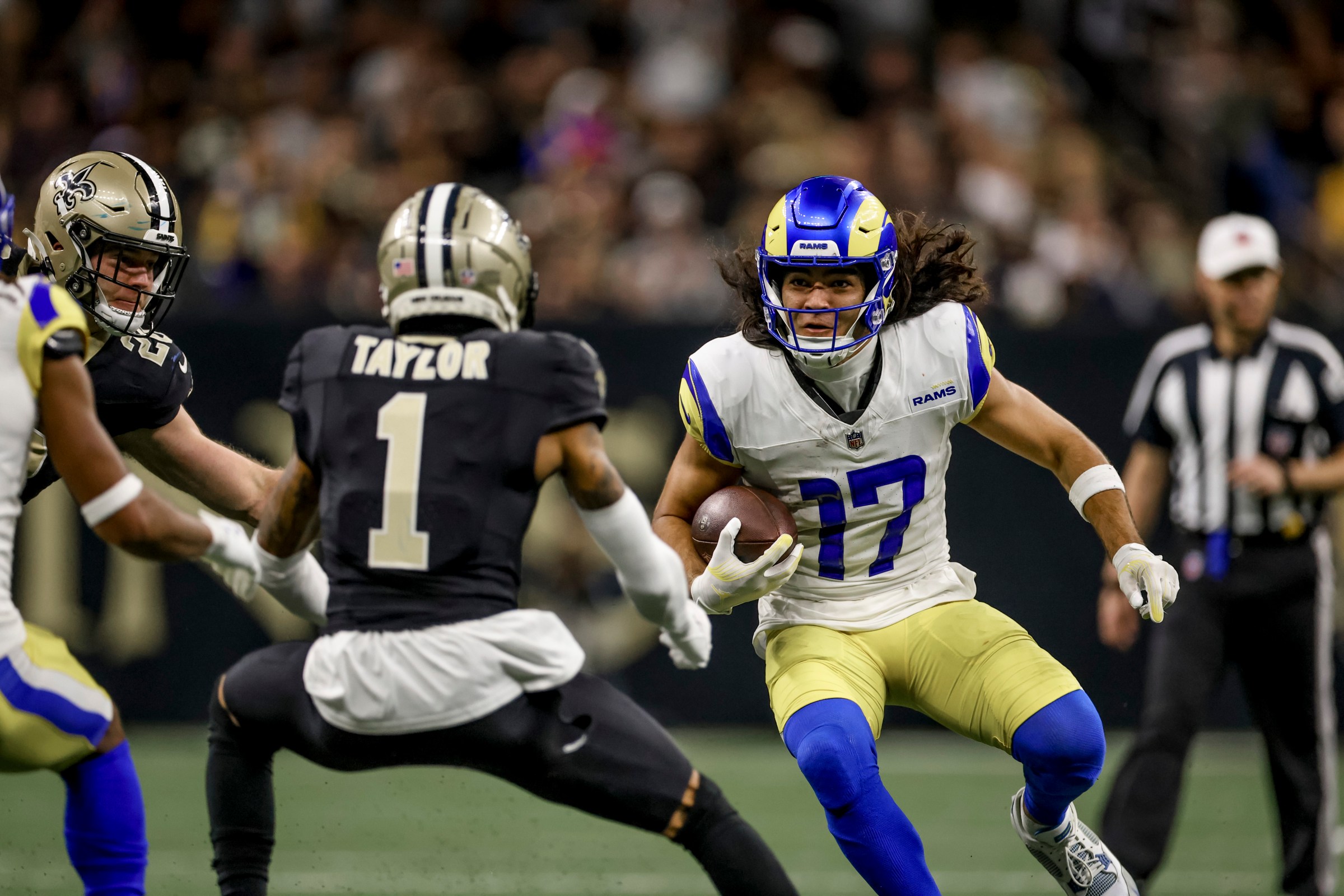NEW ORLEANS, LOUISIANA - DECEMBER 1: Puka Nacua #17 of the Los Angeles Rams is pursued by Alontae Taylor #1 of the New Orleans Saints during the second half of a game at the Caesars Superdome on December 1, 2024 in New Orleans, Louisiana. (Photo by Derick E. Hingle/Getty Images)