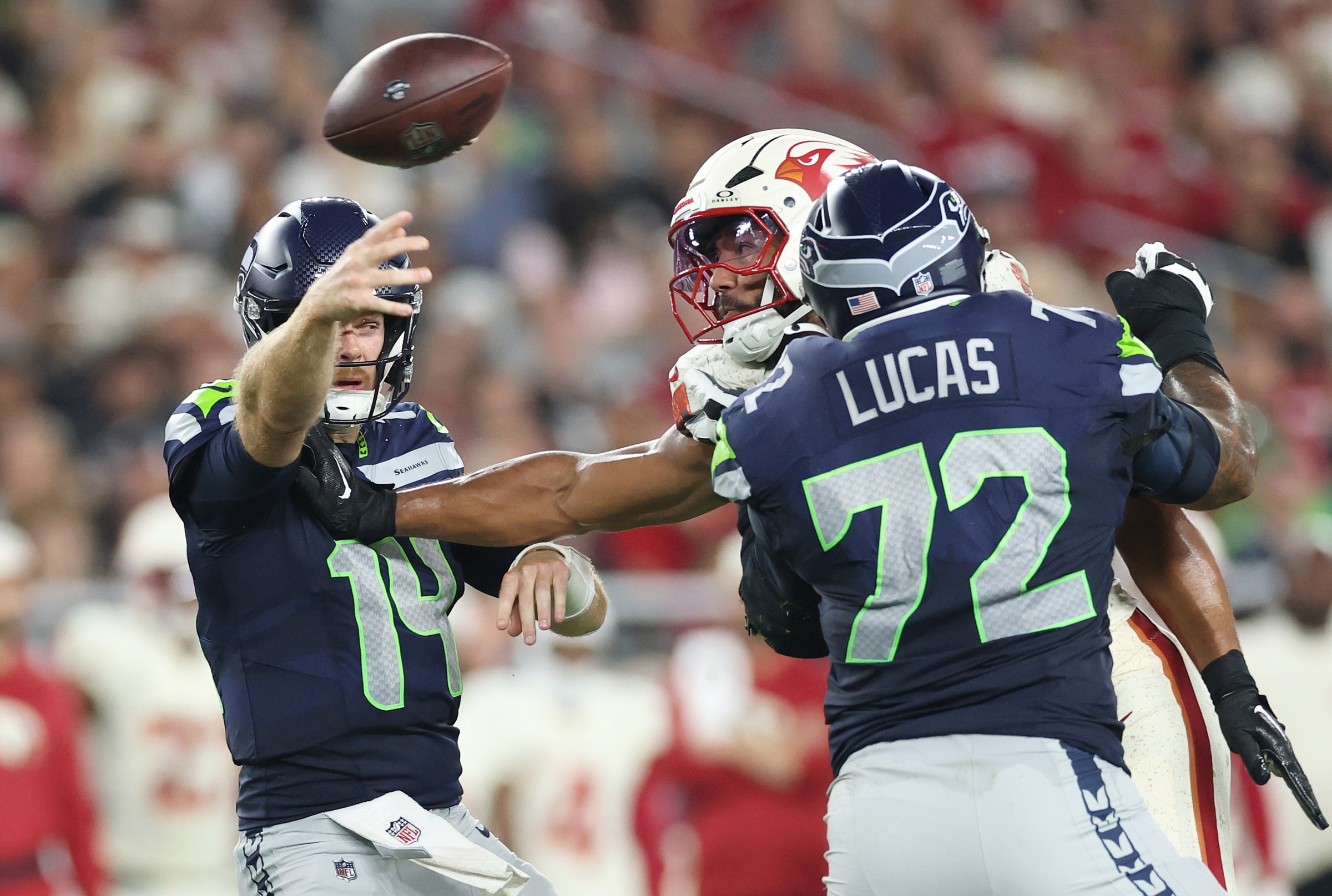 Sam Darnold #14 looks to pass under pressure from Zaven Collins #25 (Photo by Christian Petersen/Getty Images)
