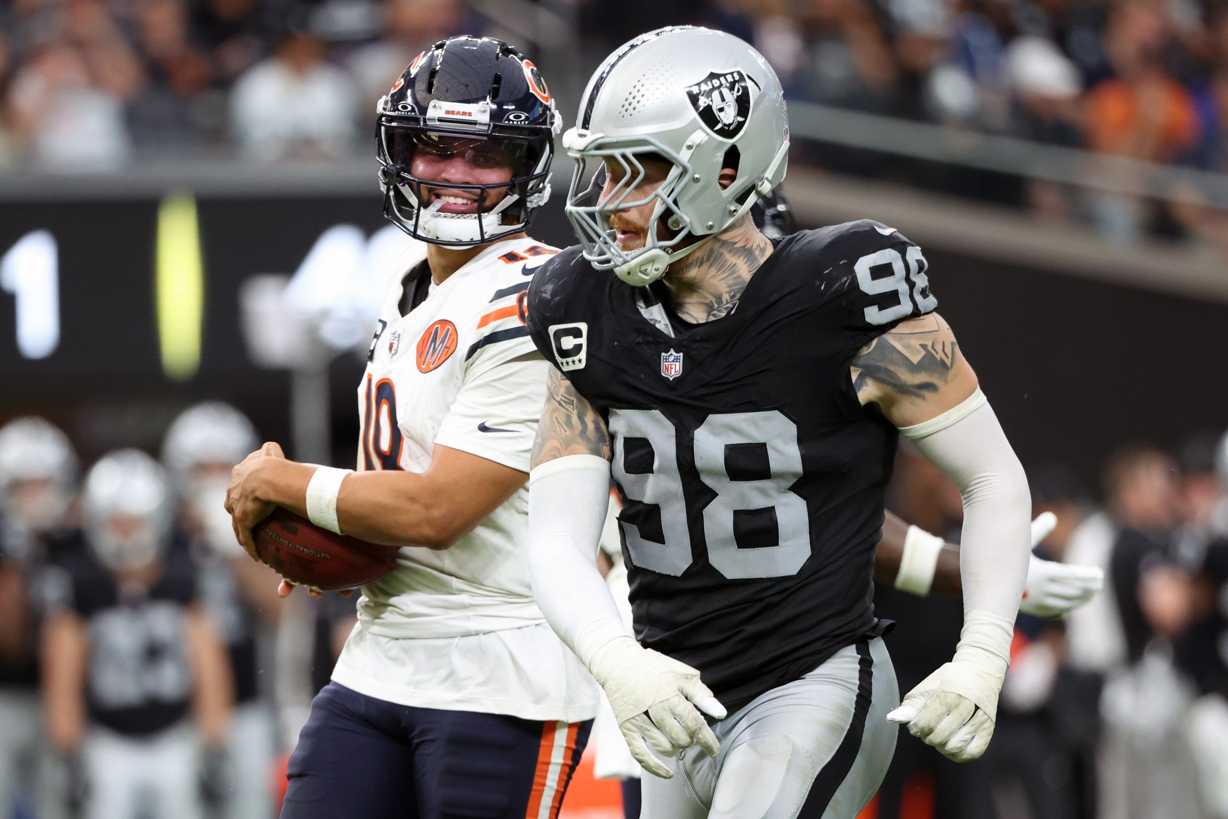 LAS VEGAS, NEVADA - SEPTEMBER 28: Caleb Williams #18 of the Chicago Bears smiles at Maxx Crosby #98 of the Las Vegas Raiders during the third quarter at Allegiant Stadium on September 28, 2025 in Las Vegas, Nevada. (Photo by Ian Maule/Getty Images)