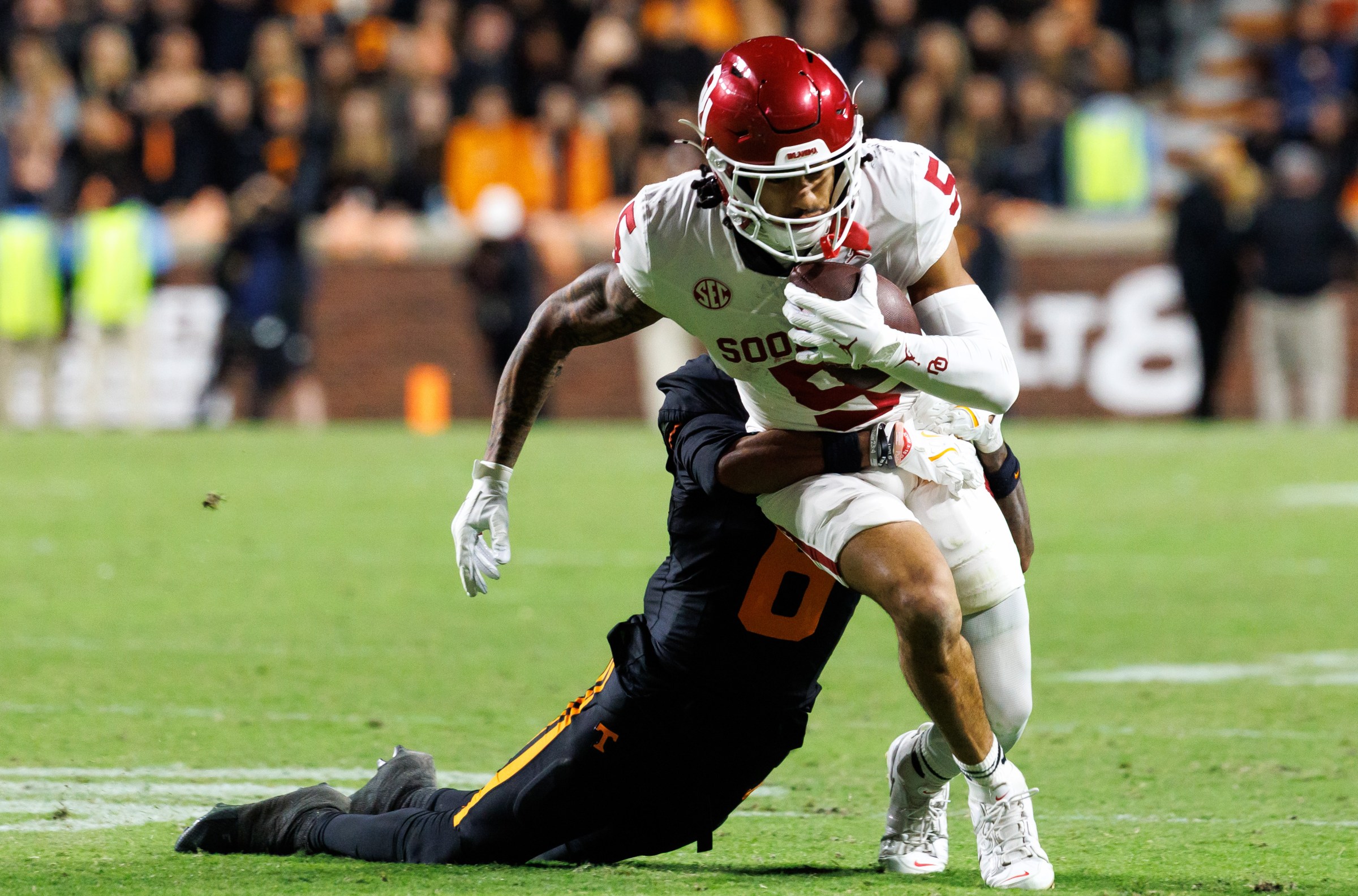 KNOXVILLE, TENNESSEE - NOVEMBER 01: Isaiah Sategna III #5 of the Oklahoma Sooners is tackled by Jalen McMurray #6 of the Tennessee Volunteers in the second half at Neyland Stadium on November 01, 2025 in Knoxville, Tennessee. (Photo by Caleb Bowlin/Getty Images)