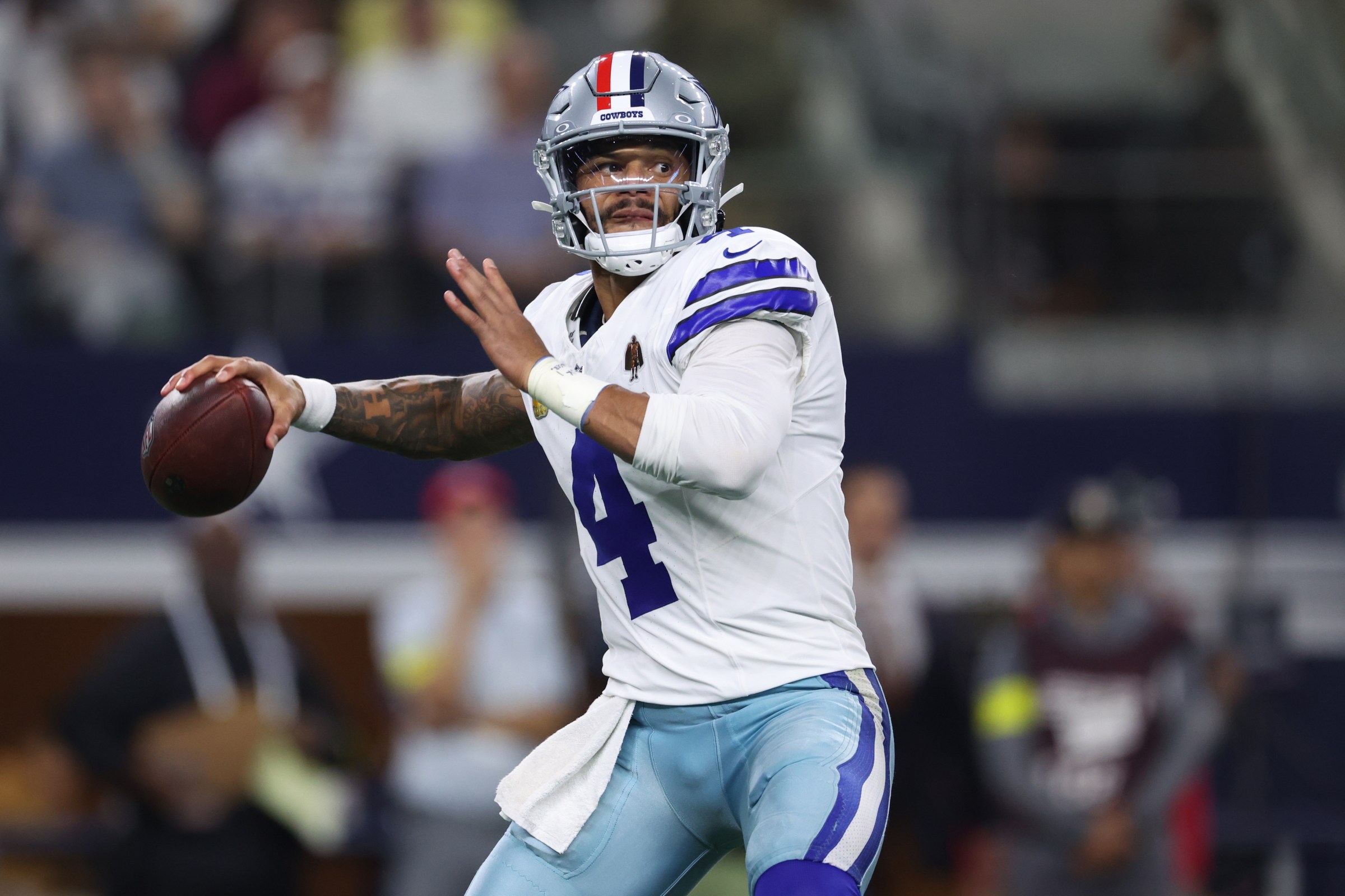 ARLINGTON, TEXAS - NOVEMBER 03: Dak Prescott #4 of the Dallas Cowboys throws ahead of Josh Sweat #10 of the Arizona Cardinals during the second quarter in the game at AT&T Stadium on November 03, 2025 in Arlington, Texas. (Photo by Sam Hodde/Getty Images)