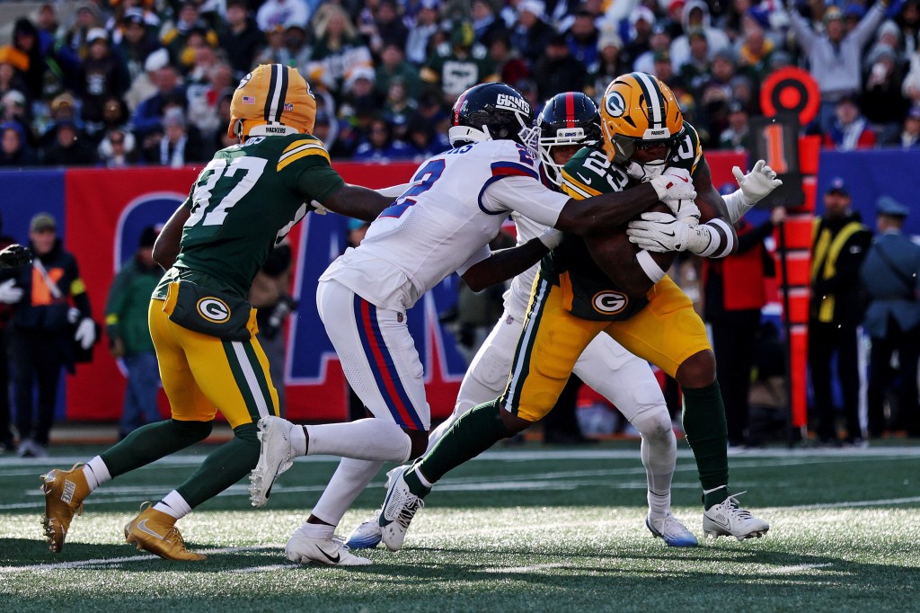 Green Bay Packers running back Emanuel Wilson (23) runs for a touchdown against New York Giants cornerback Deonte Banks (2).