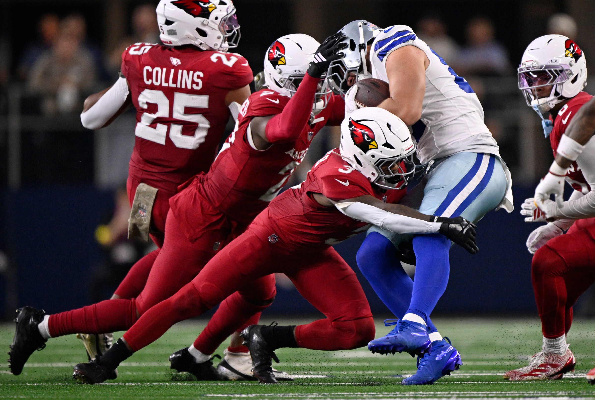Nov 3, 2025; Arlington, Texas, USA; Arizona Cardinals safety Budda Baker (3) and linebacker Akeem Davis-Gaither (27) tackle Dallas Cowboys tight end Jake Ferguson (87) in the first half at AT&T Stadium. Mandatory Credit: Jerome Miron-Imagn Images