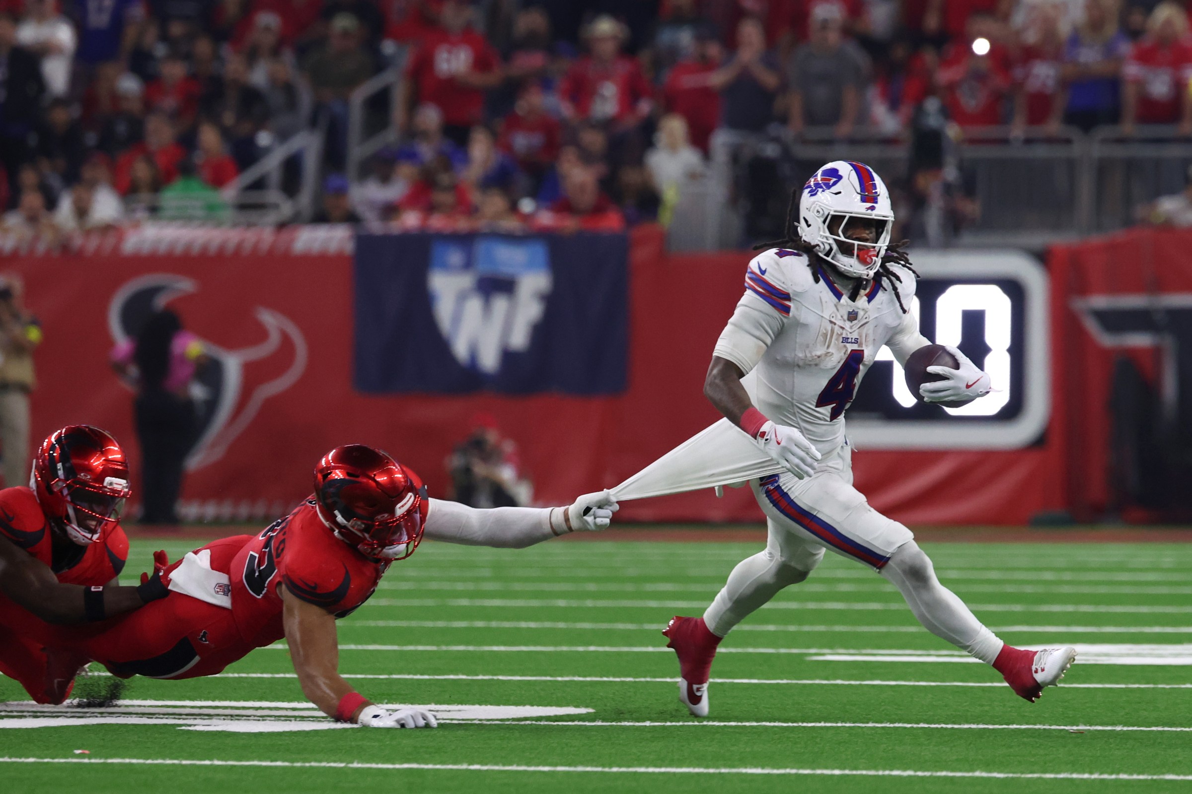 Nov 20, 2025; Houston, Texas, USA; Buffalo Bills running back James Cook III (4) runs against Houston Texans linebacker Henry To’oTo’o (39) in the fourth quarter at NRG Stadium. Mandatory Credit: Thomas Shea-Imagn Images