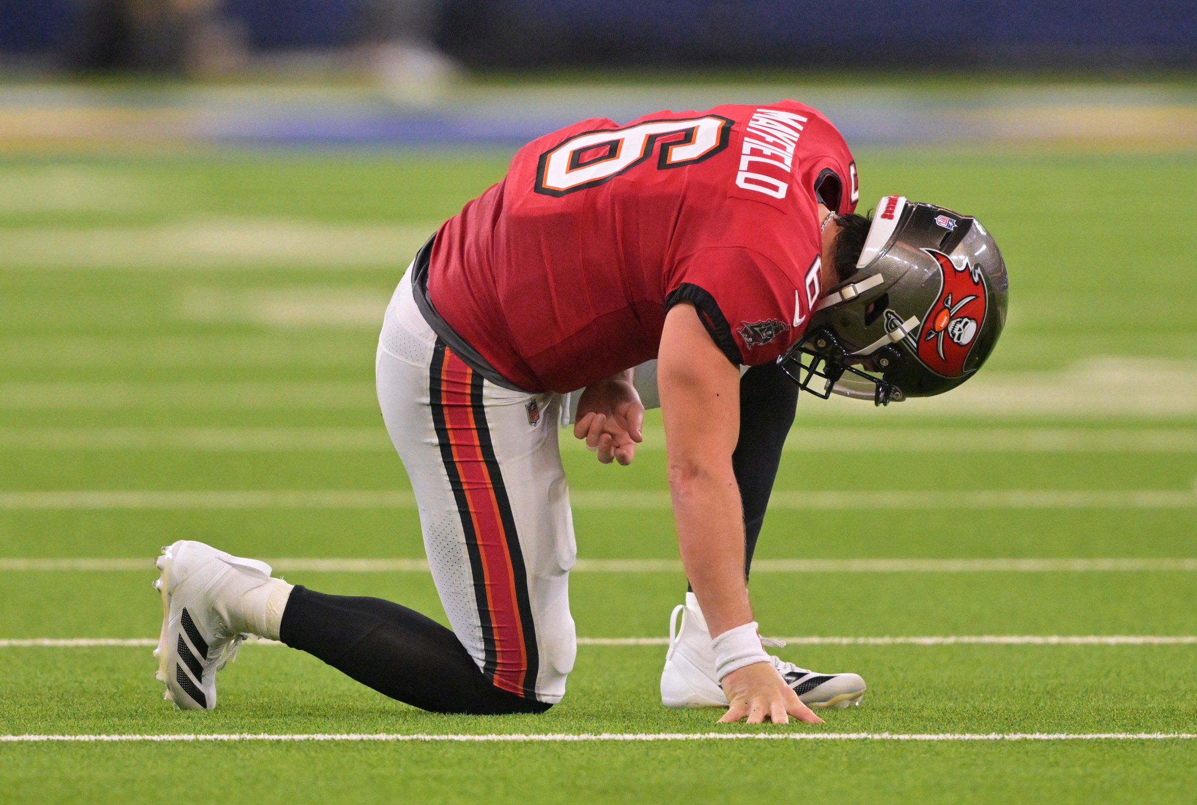 Nov 23, 2025; Inglewood, California, USA; Tampa Bay Buccaneers quarterback Baker Mayfield (6) kneels on the field with an apparent injury against the Los Angeles Rams during the second quarter at SoFi Stadium. Mandatory Credit: Jayne Kamin-Oncea-Imagn Images