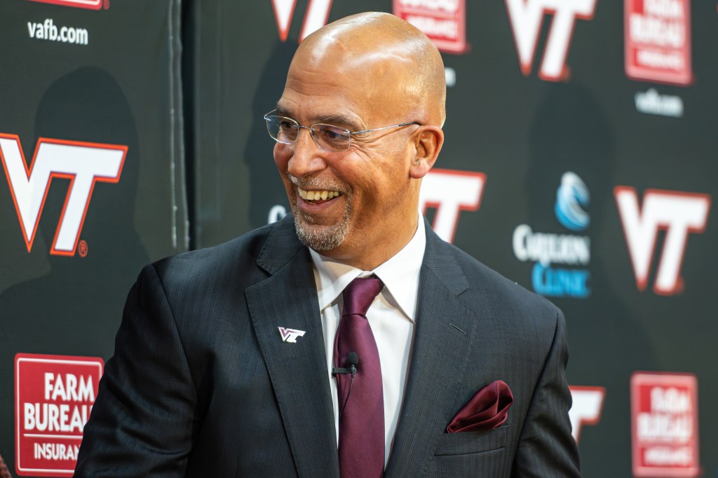 James Franklin, Virginia Tech's new head football coach, smiles during a news conference.