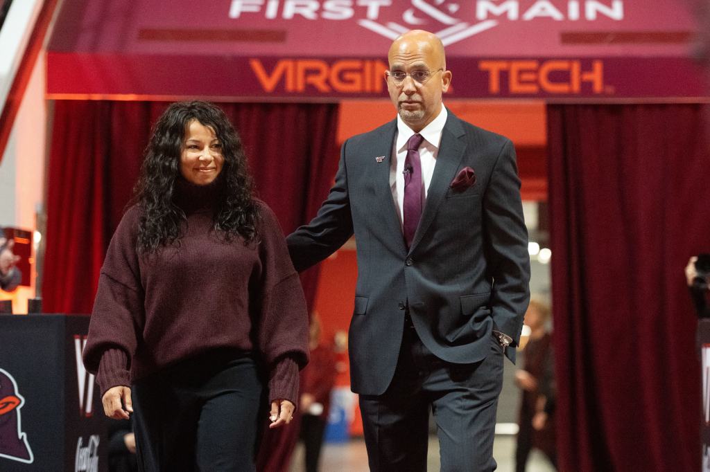 James Franklin and his wife Fumi arrive at a news conference to introduce Franklin as Virginia Tech's new head football coach.