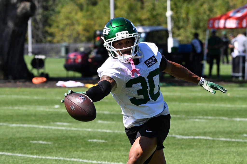 Jets cornerback Michael Carter II (30) practices with a football in Florham Park, NJ.
