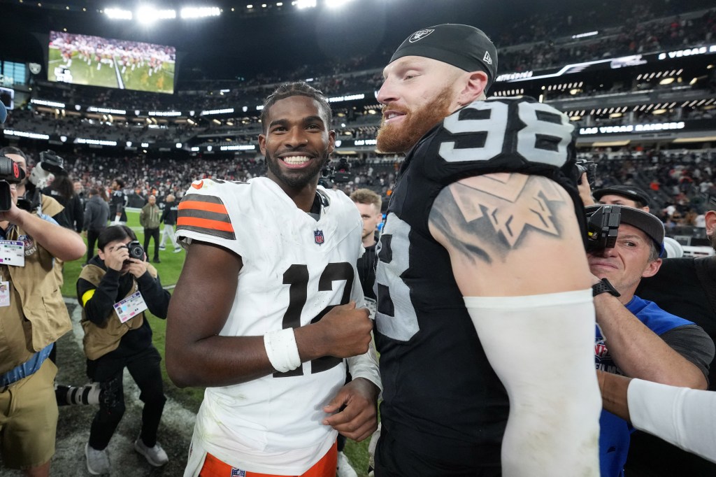 Las Vegas Raiders defensive end Maxx Crosby (98) and Cleveland Browns quarterback Shedeur Sanders (12) embrace after the game at Allegiant Stadium on November 23, 2025. 