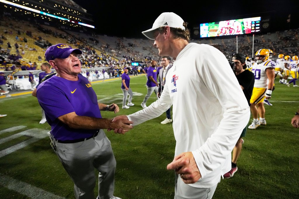 LSU head coach Brian Kelly, left, greets Louisiana Tech head coach Sonny Cumbie after a college football game.