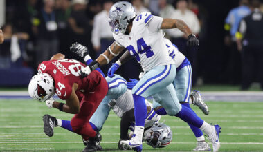 Elijah Higgins #84 of the Arizona Cardinals rushes ahead of Marshawn Kneeland #94 of the Dallas Cow...