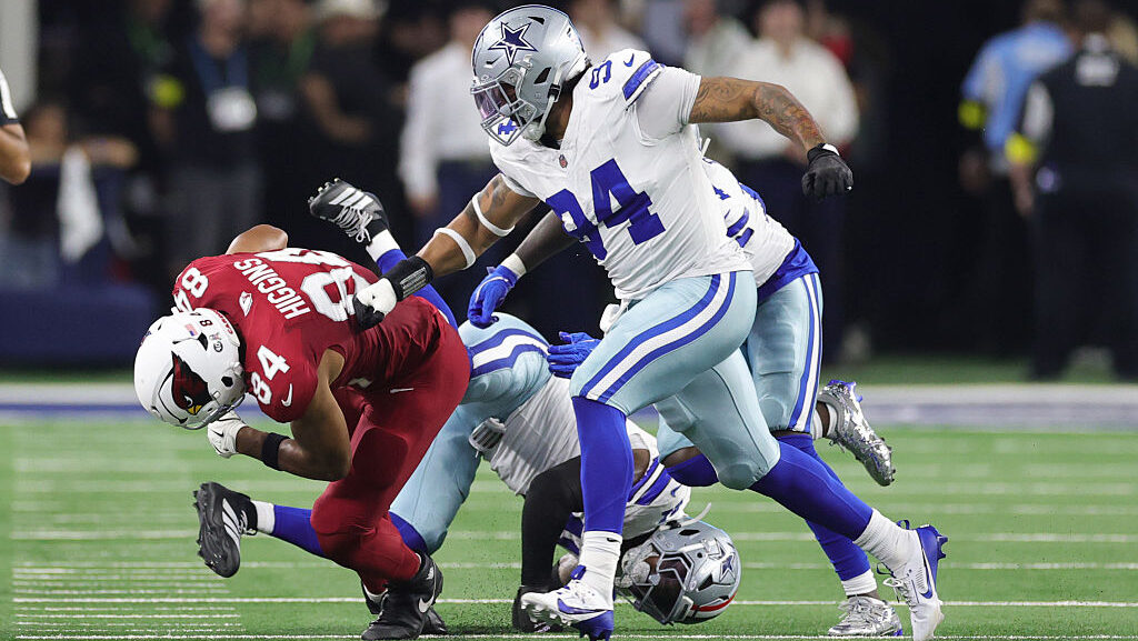 Elijah Higgins #84 of the Arizona Cardinals rushes ahead of Marshawn Kneeland #94 of the Dallas Cow...