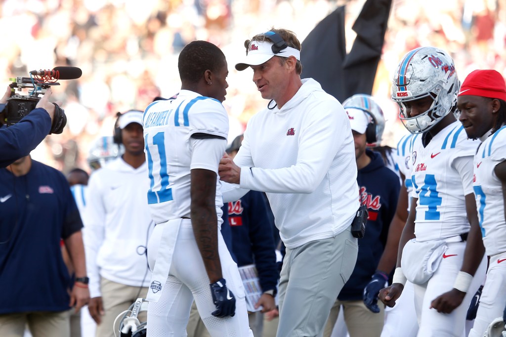 Mississippi Rebels head coach Lane Kiffin reacting with wide receiver Deuce Alexander