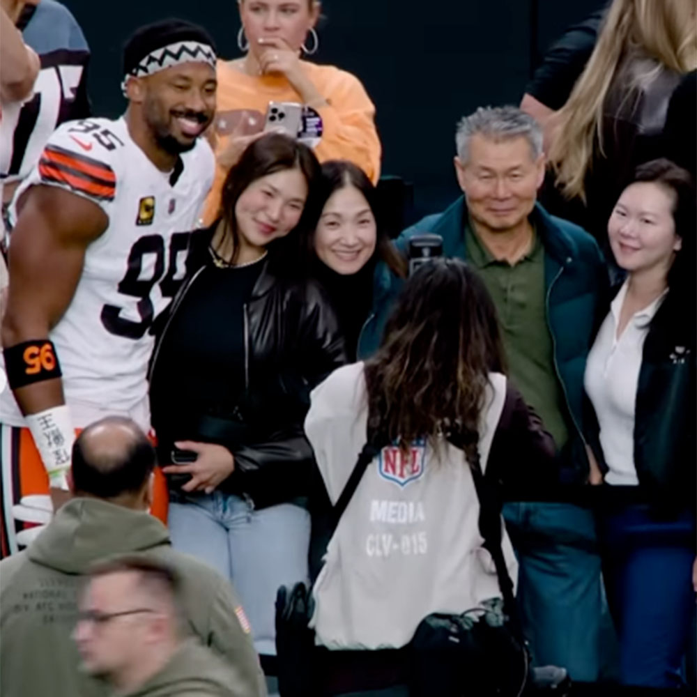 Browns defensive end Myles Garrett and Olympic snowboarder Chloe Kim on the sideline before Cleveland's game against the Raiders at Allegiant Stadium on November 23, 2025.