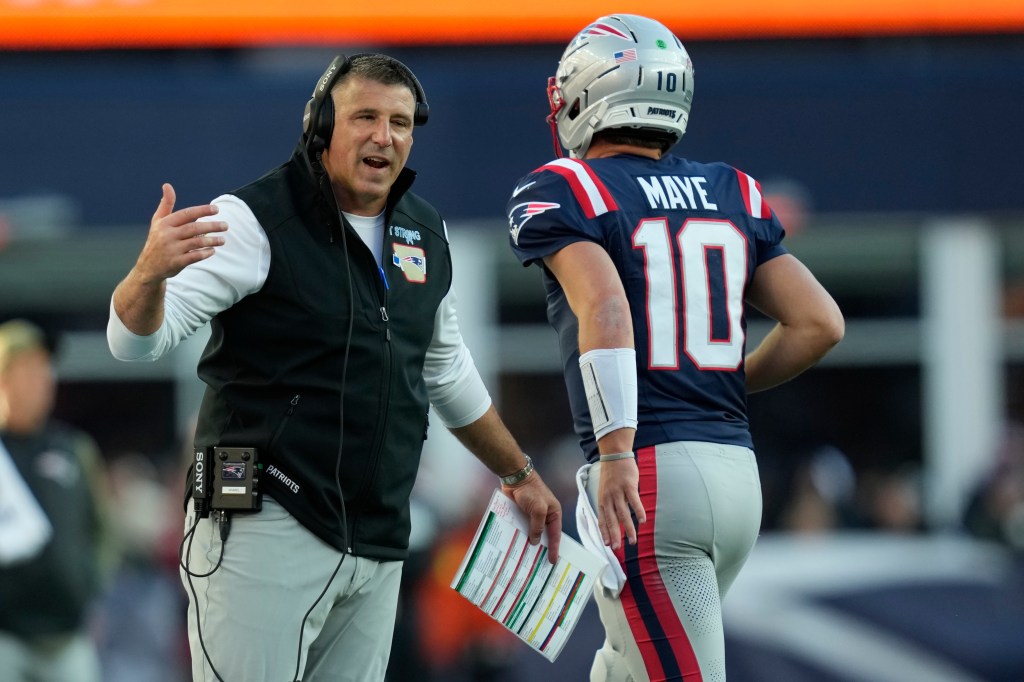Patriots coach Mike Vrabel with quarterback Drake Maye during the team's Week 9 win over the Falcons.