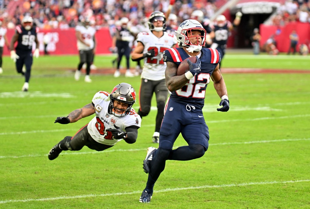 New England Patriots running back Treveyon Henderson (32) runs for a touchdown past Tampa Bay Buccaneers cornerback Josh Hayes (32).
